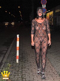 Lady Lena : In the darkness of this hot summer night, the always horny Lady Lena dares to go out on the streets in the middle of the city in a transparent catsuit. But even if she thinks nobody sees her: Lena is being watched. Because in her transparent suit, the Big-Boob-Lady is an ideal wanker template for voyeurs.