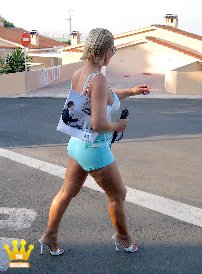 Lady Barbara : In the warm afternoon sun, I am walking only in hot pants and 14 cm high heeled mules in Spain through the urbanisation. Then I take a last sun bath still naked on the terrace and at the end I jump naked in the pool.