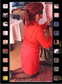 HD-Video with Lady Gina : Lady Gina is visited by a fan at home in this 10-minute video. In an elegant, red business suit, black seamed nylons and 15 cm high-heeled mules, the businesswoman welcomes the corpulent man in her small apartment in Düsseldorf. With an updo and dark sunglasses with which she can