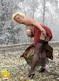 Lady Katinka : Lady Katinka takes off her fur coat in a parking lot at the Nuerburgring. In a tartan mini-skirt, hold-up black nylons and sandals, the blonde secretary shows off her tied boobs in a foggy winter background.  Incl. 6min Video