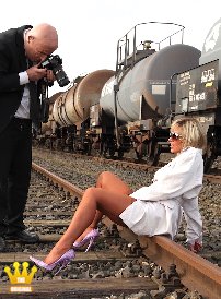 Lady Ewa : Member Upskirt is allowed to take a picture from LadyEwa  in front of a train at a freight yard. The sexy Polish woman is posing in a light trench coat with sheer, light brown nylon stockings on suspenders and 16 cm high pumps on her feet. In a track bed it is not so easy to go on such shoes. Thats why Ewa has to sit on the rails every now and then. She likes to show Upskirt her little lace panties then.