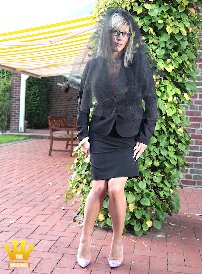 Lady Ewa : The Lady is posing today as a grieving widow in a black costume, veil, ultra sheer beige nylon stockings and 16cm high heeled pumps, but she forgot the slip.  What she probably thinks? At the End of the serie, she lifts her skirt and rubbs her shaved pussy.