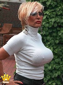 Lady Barbara : Today I am presenting my big boobs to you under a white, very thin turtleneck sweater. As you can imagine they are tied tightly with rubber bands. The nipples stick out so that it looks like they want to pierce the sweater. Im wearing black leather hotpants underneath and black crocodile pumps on my feet. Can I go shopping right away, or is that too daring? What do you think?