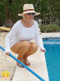 Lady Barbara : In a white sweater and summer hat Im cleaning the pool of an old friend on the Costa Blanca today. Since nobody lives there, I can do it only in sheer beige seamed tights and my garden wedge mules. Hopefully the old man and his wife wont suddenly come back at the moment from their tour to Germany. If you are interested in my mules, please contact me.