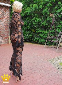 Lady Barbara : Only in a transparent lace dress without bra and panties, but with very high platform pumps on my feet I am posing for you today in the garden. Should I venture into the city dressed like this? What do you think? Is that too daring or not? In any case, you can meet me again in summer in such a closed lace dress (catsuit) on a sleep date. However, I don